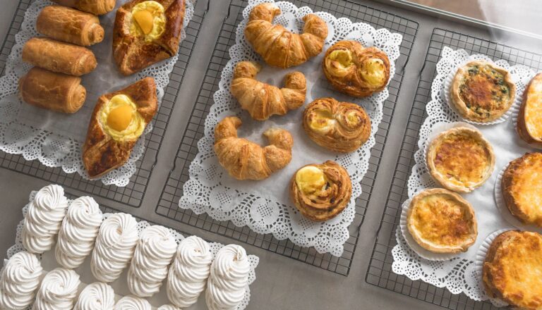 Viennoiseries, tarts and meringues on display trays