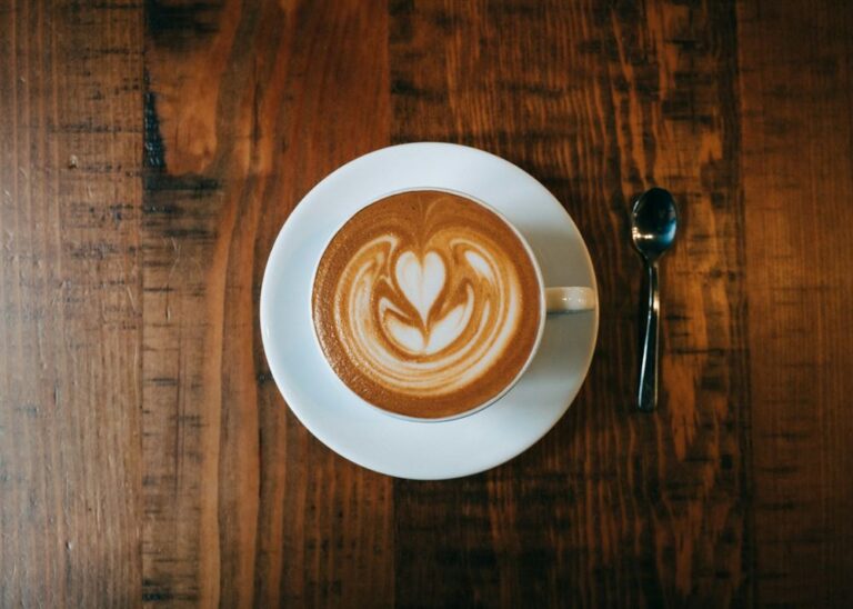 Latte art seen from above on a wooden table