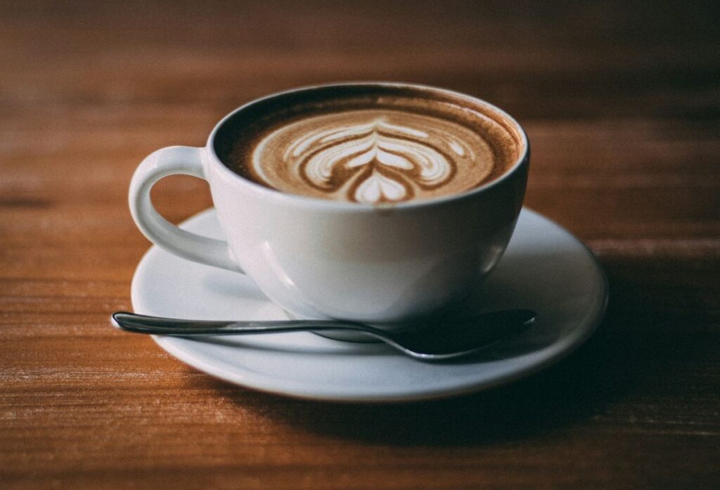 Latte with latte art in a white cup