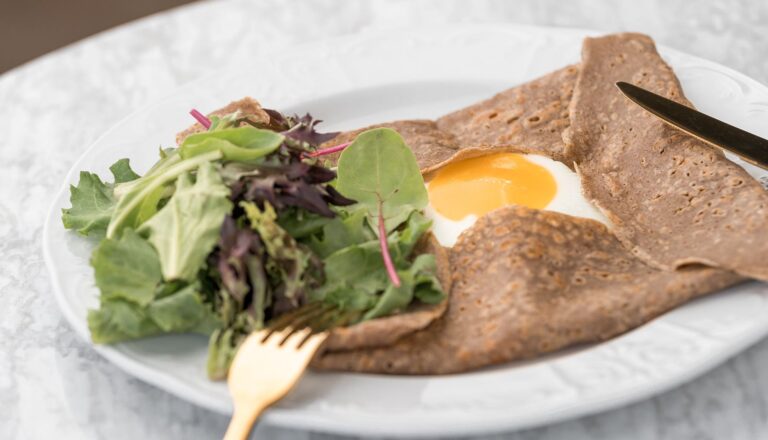 Savory crepe with a fried egg and mixed greens